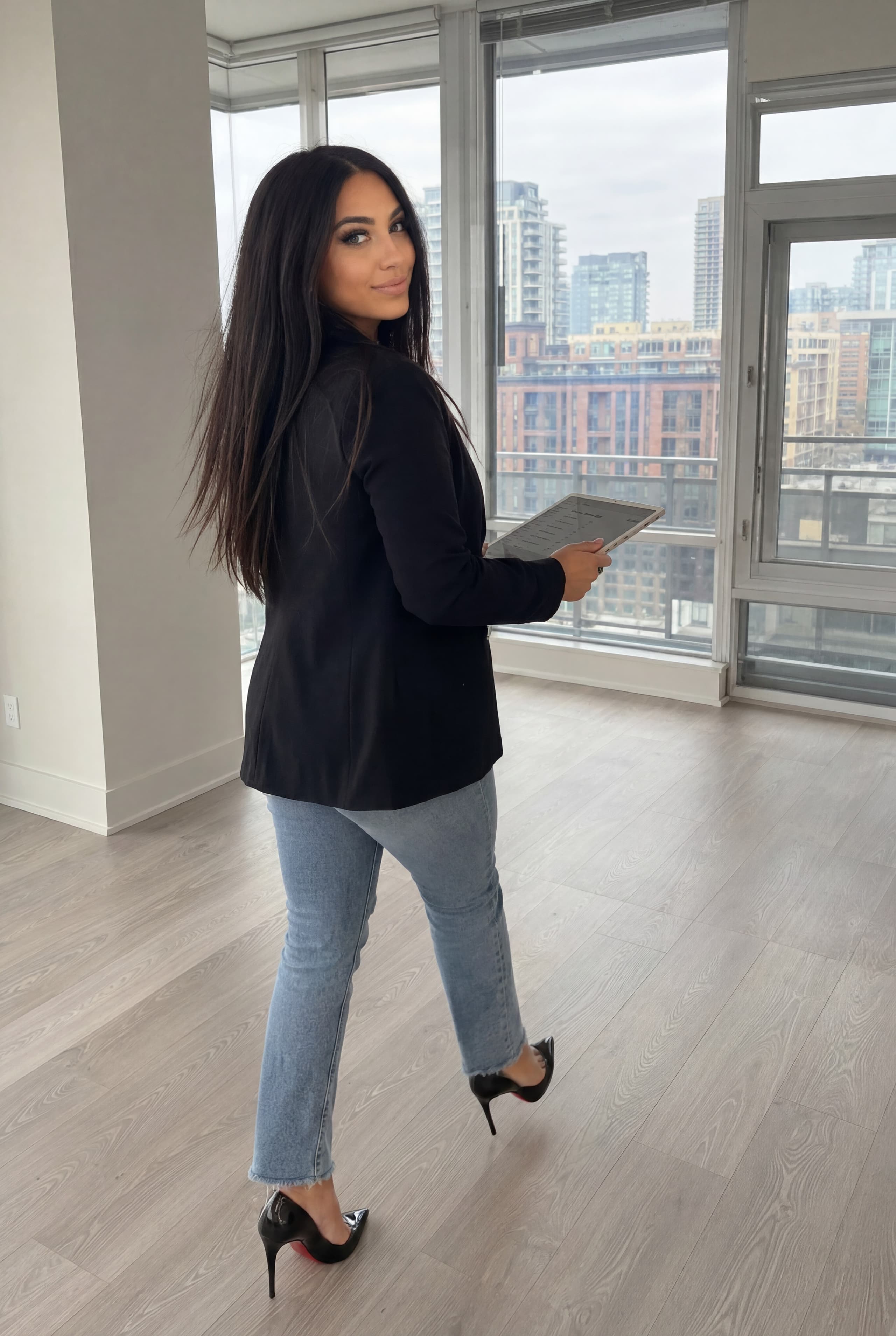 Stephanie Chidiac reviewing a Toronto condominium with city views